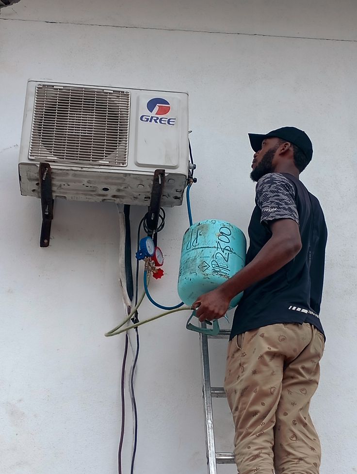 A technician installing an air-conditioner